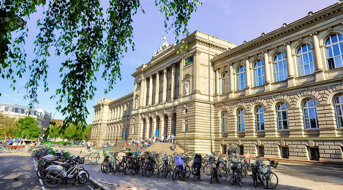 Bikes in the foreground in front of the steps of the University Library of Strasbourg